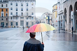 Man walking in the city with umbrella on rainy day