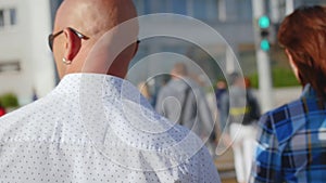 Man walking through the Crowd of People in the Big City. Crossing the street. Close up shot.