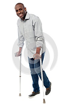 Man walking with crutches isolated on a white