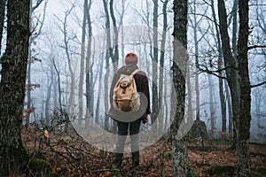 Man walking on a dark path through a spooky forest