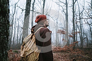 Man walking on a dark path through a spooky forest