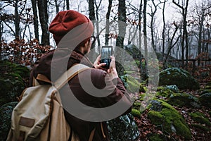 Man walking on a dark path through a spooky forest