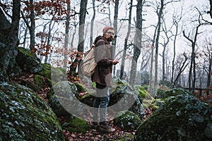 Man walking on a dark path through a spooky forest