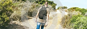 Man walking by a dirt road, web banner