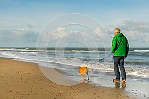 Man walking with dog at beach