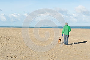 Man walking with dog at the beach