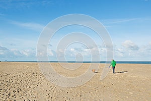 Man walking with dog at the beach