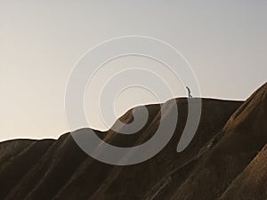 Man walking down a hill