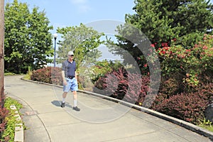 Man walking down sloped sidewalk