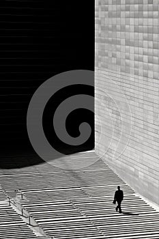 A man walking down stairs in front of a building, AI