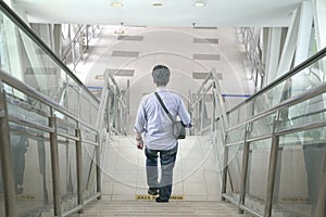 Man walking down the stairs inside a subway building