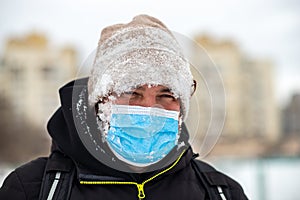 a man walking down the street wearing a protective mask close-up