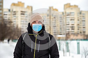 a man walking down the street wearing a protective mask middle plan