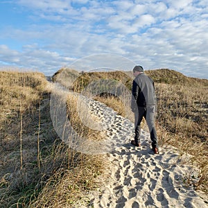 Man Walking Dunes to the Beach Outer Banks NC