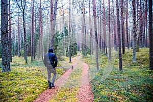 Man walking in forest and dog