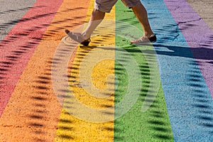 Man walking on gay rainbow crosswalk in Montreal gay village