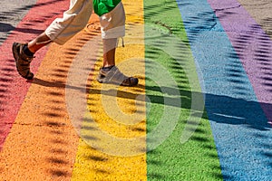 Man walking on gay rainbow crosswalk in Montreal gay village