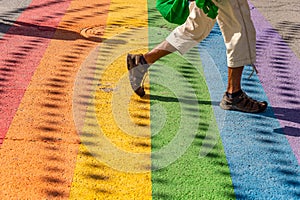 Man walking on gay rainbow crosswalk in Montreal gay village