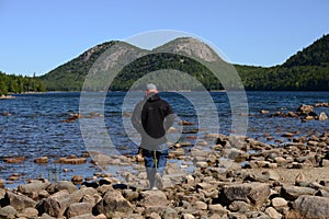 Man walking or hiking through Acadia National Park in Maine