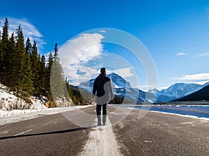 Man walking on the Icefields parkway Highway 93Ã  in Alberta