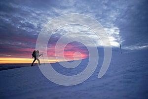 Man walking in the mountains by sunset