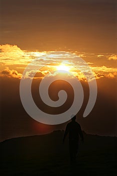 Man walking off into sunset