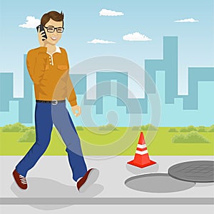 Man walking into open manhole looking at his smartphone. Smartphone addiction