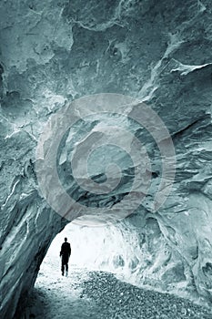 Man walking out of a cave