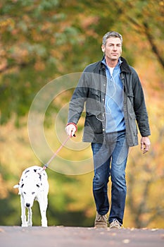 Man Walking Through Park Listening to MP3 Player photo