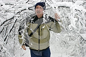 Man Walking through Snow Filled Branches 2