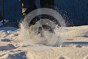 Man Walking On Snow With Shoe Spikes