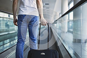 Man walking with suitcase at airport terminal