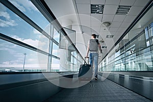 Man walking with suitcase at airport terminal