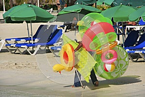 Man walking with swim matresses and rings, Boca Chica beach photo