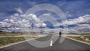 A man walking on the tibetan road