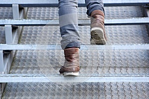 Man walking up stairs in boots