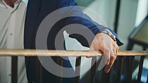 A Man Walking Up the Stairs Holding the Bannister