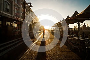 Man walking on waterfront harbor cape town with sunset