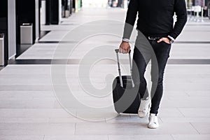 Man walking with wheeled bag