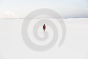 Man walking at White Sands National Monument in Alamogordo, New Mexico.