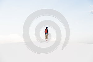 Man walking at White Sands National Monument in Alamogordo, New Mexico.