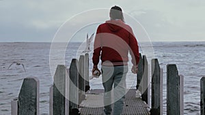 Man walking in the wooden pier