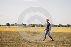 A man walks through an agricultural field. photo