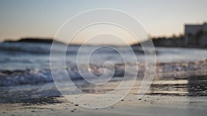 Man walks along the coastline at sunset legs close-up slow motion