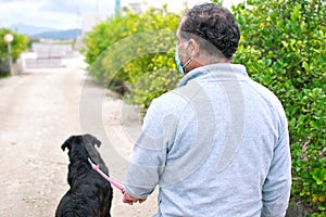 A man walks with his dog outdoors after Spain imposed a lockdown to slow down the spread of the coronavirus disease in Murcia,
