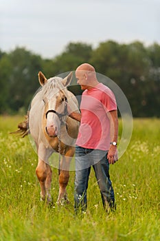 A man walks with his horse