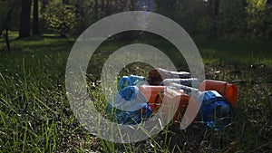 A man walks through a pile of rubbish in the forest, pollution of nature