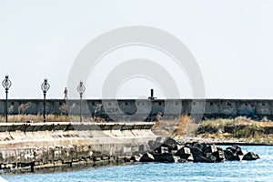 A man walks on seawall