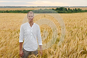 Man walks on summer wheat field, nature beauty