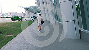 a man walks to a car parking
